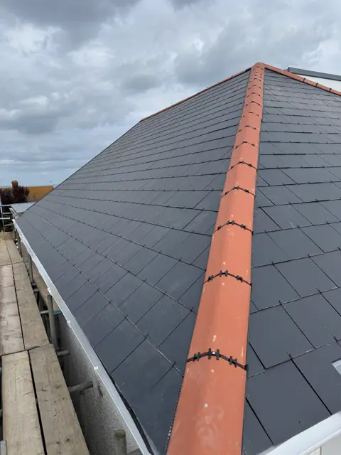 Sharp slate hip, fills the frame: slate roof by LR Roofing near Weymouth, Dorset