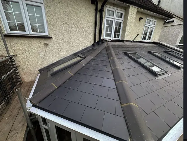 Slate extension roof with rooflights: slate roof by LR Roofing near Weymouth, Dorset