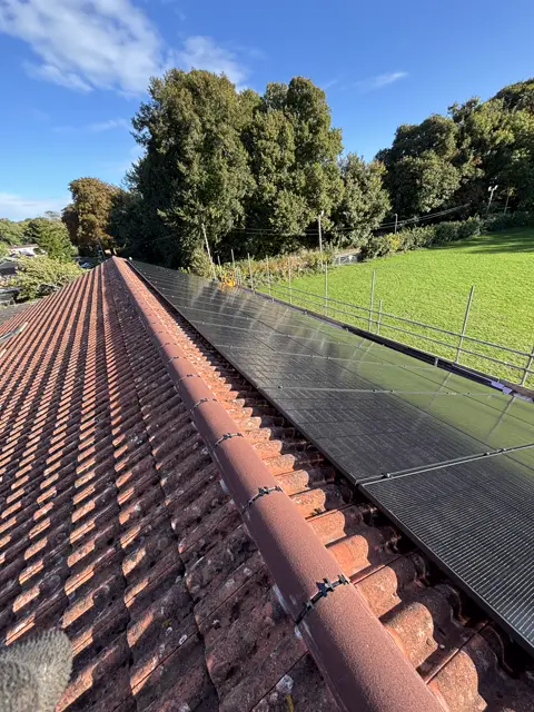 Fresh ridge pointing along solar panels: leadwork and chimney by LR Roofing near Weymouth, Dorset