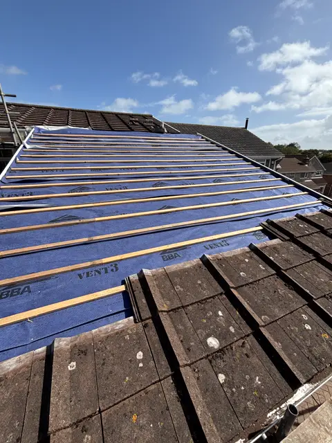 Neat batten lines, crisp blue sky: tile roof by LR Roofing near Weymouth, Dorset